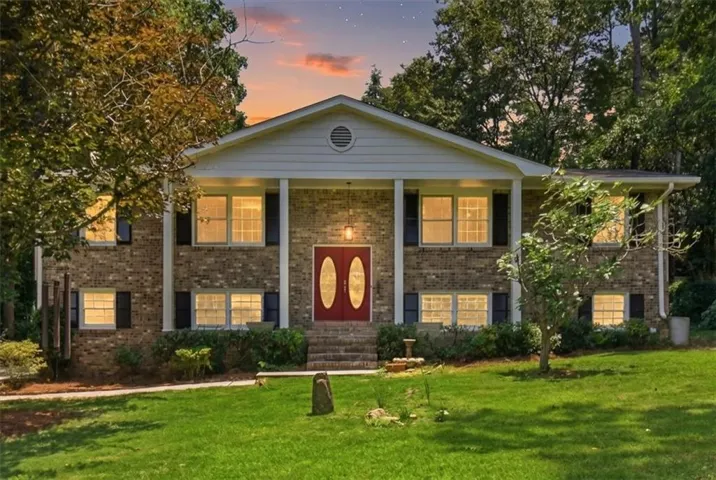 Brick exterior with a prominent red double-door entry