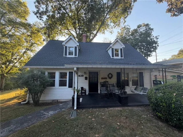 White siding exterior with a dark shingle roof