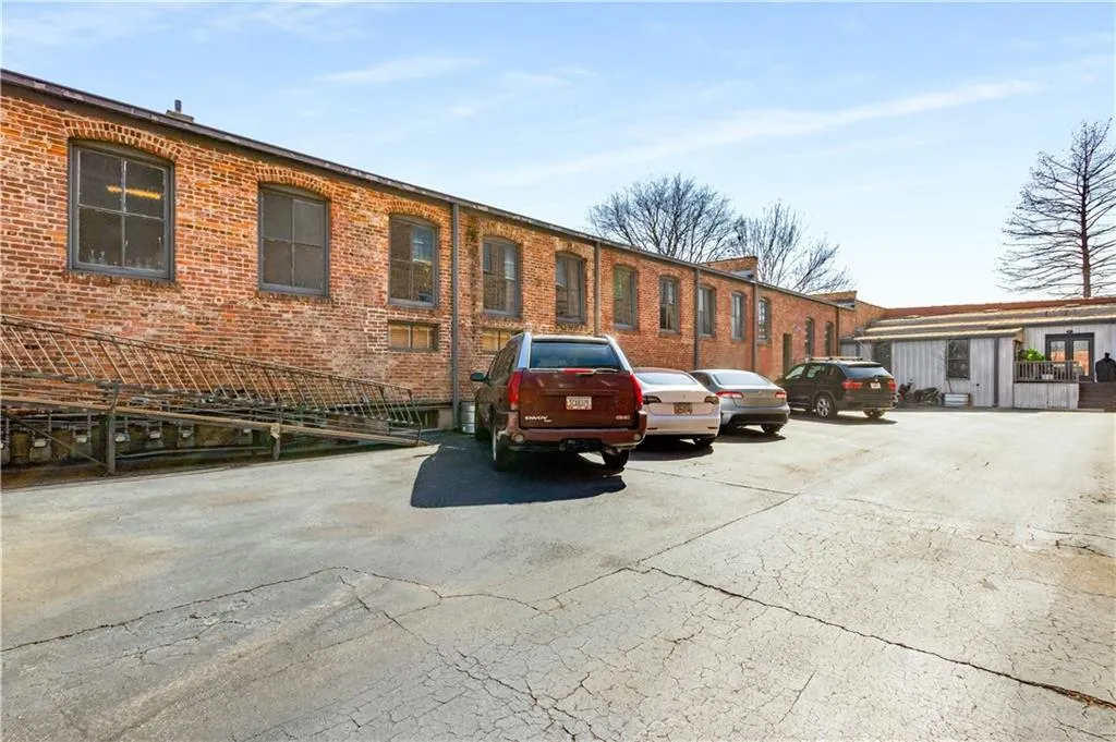 View of building exterior featuring uncovered parking