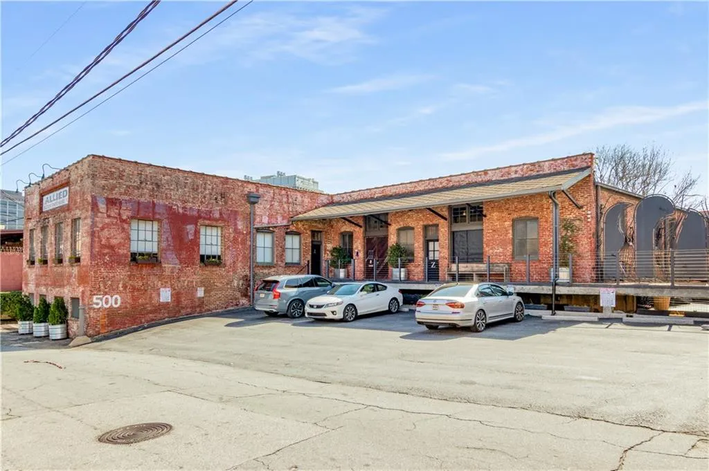 View of property featuring uncovered parking