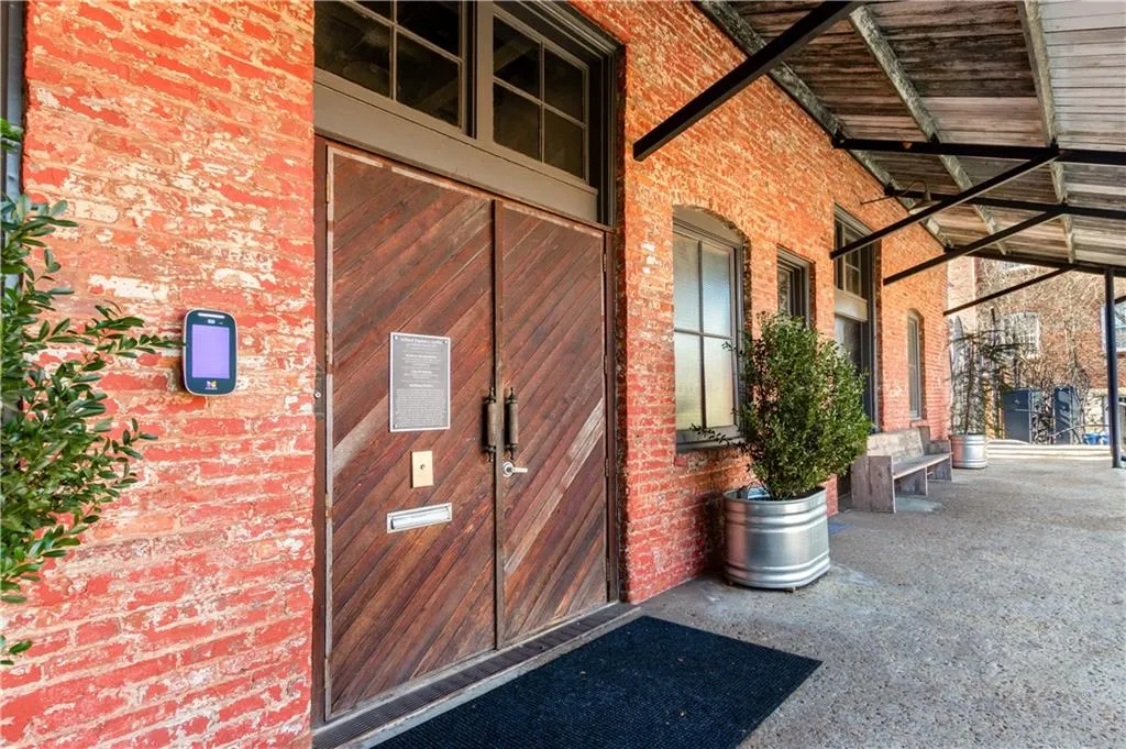 Doorway to property featuring brick siding and a patio