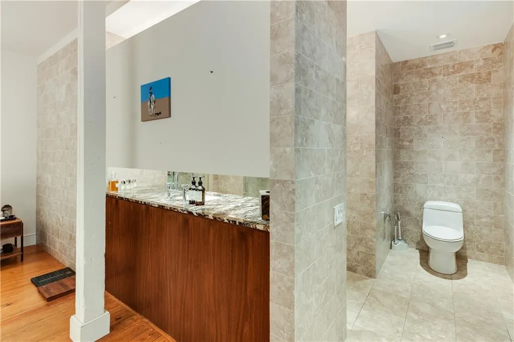 Bathroom featuring tile walls and vanity