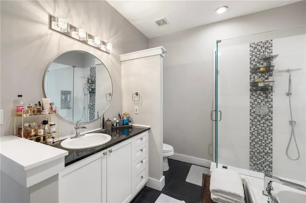 Full bathroom with a shower stall, vanity, tile patterned flooring, and recessed lighting