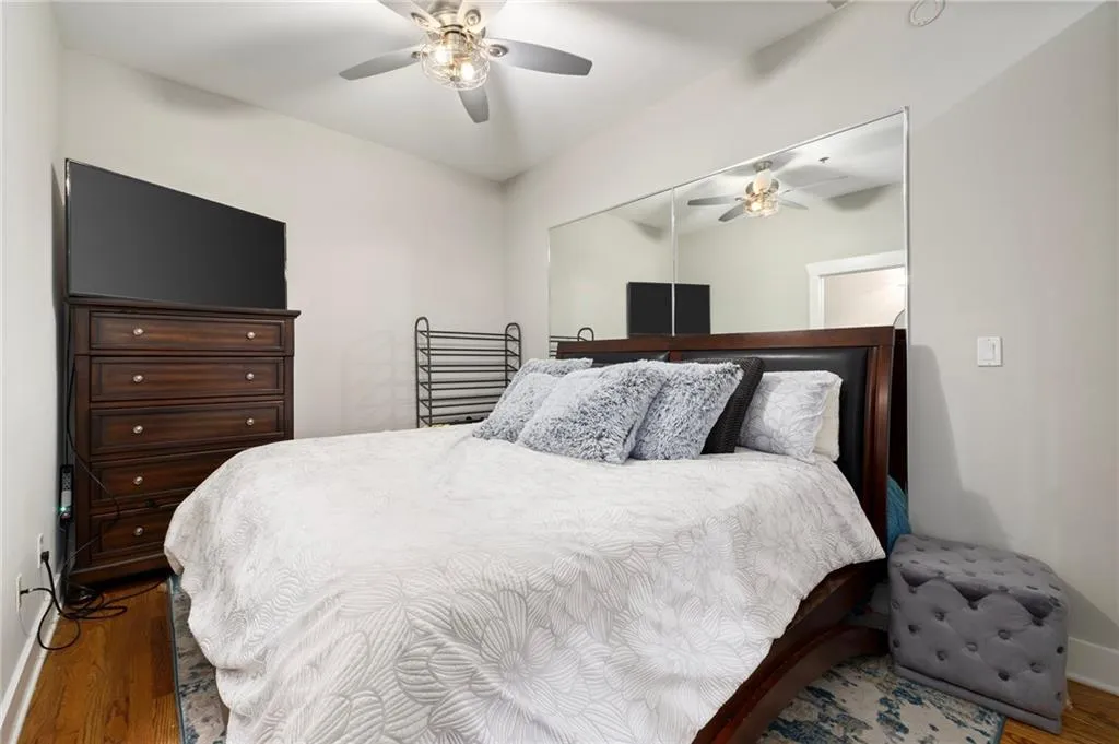 Bedroom featuring wood finished floors, a ceiling fan, and a closet