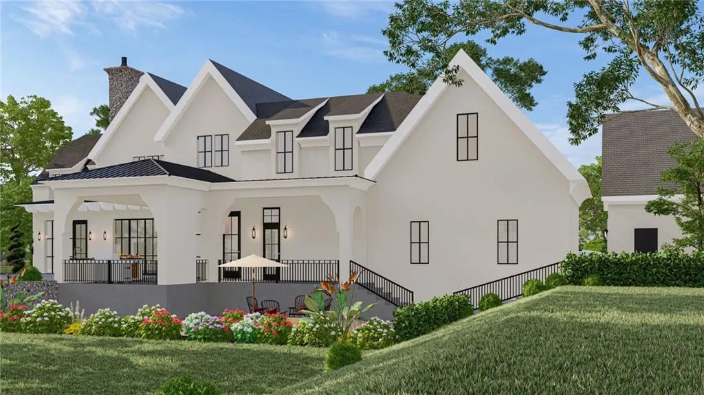 Rear view of property featuring stucco siding, a chimney, a lawn, and a standing seam roof