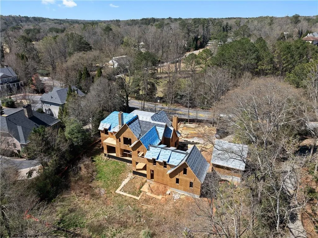 Birds eye view of property featuring a view of trees