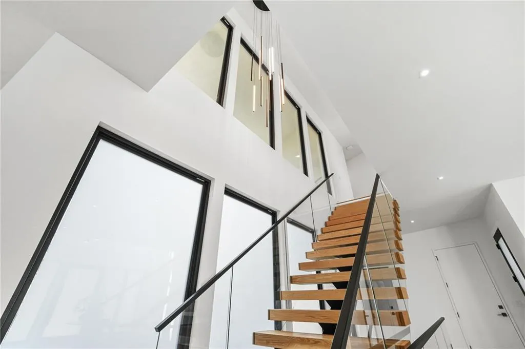 Floating wood tread staircase with glass railing
