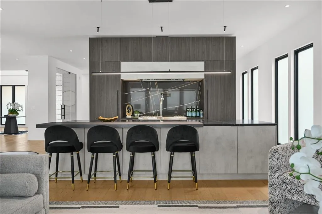 Modern kitchen island with a dark countertop and integrated sink