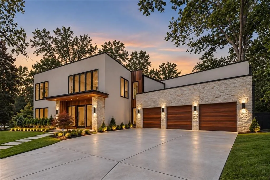 Modern architectural exterior with extensive window lines, a stone veneer facade, and a three-car garage