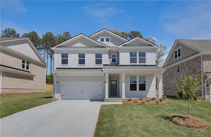 Stunning two-story colonial featuring a clean, modern facade with board-and-batten siding and architectural details