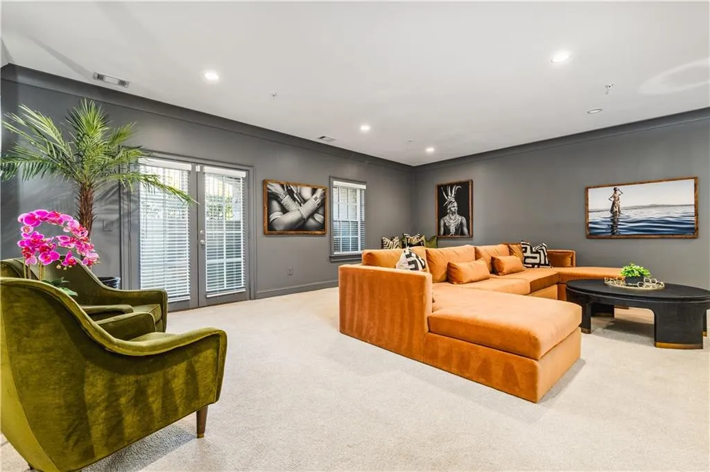 Living area with recessed lighting, carpet flooring, visible vents, and baseboards