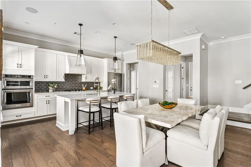 Dining room with dark wood-style floors, ornamental molding, visible vents, and recessed lighting