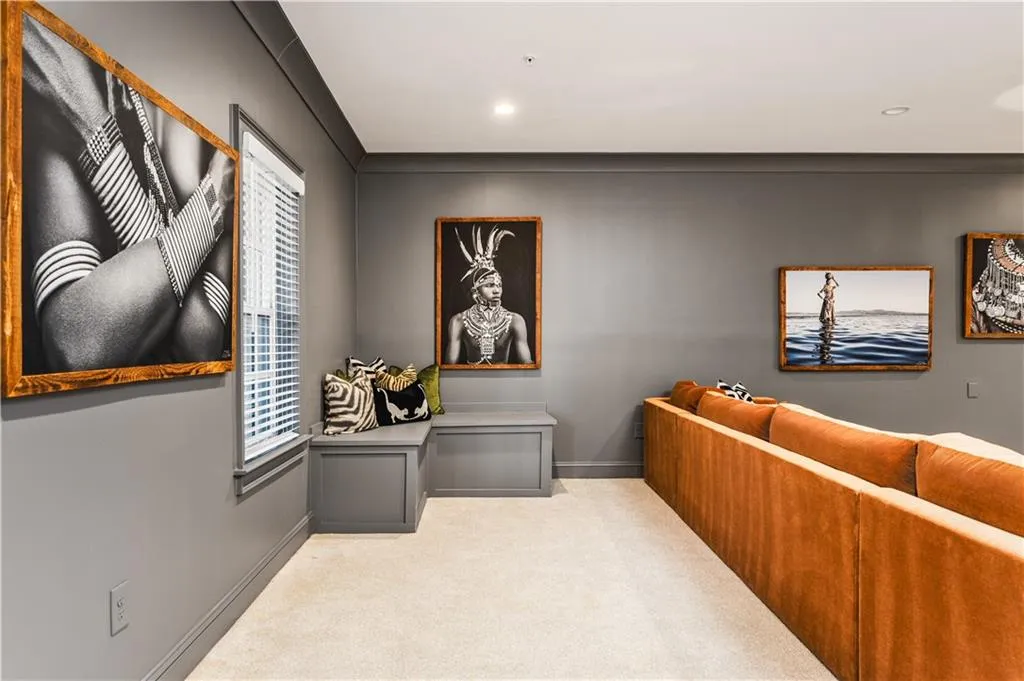 Carpeted home theater room with recessed lighting and baseboards