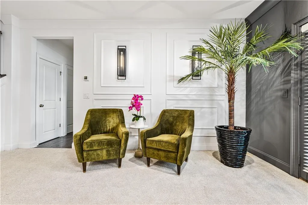 Living area with carpet flooring and a decorative wall