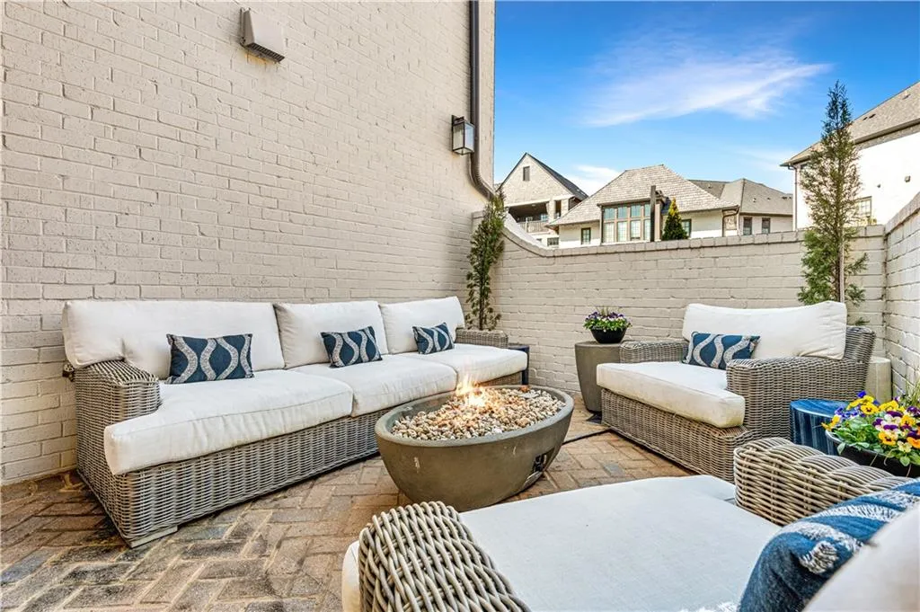 View of patio with a fenced backyard and an outdoor living space with a fire pit
