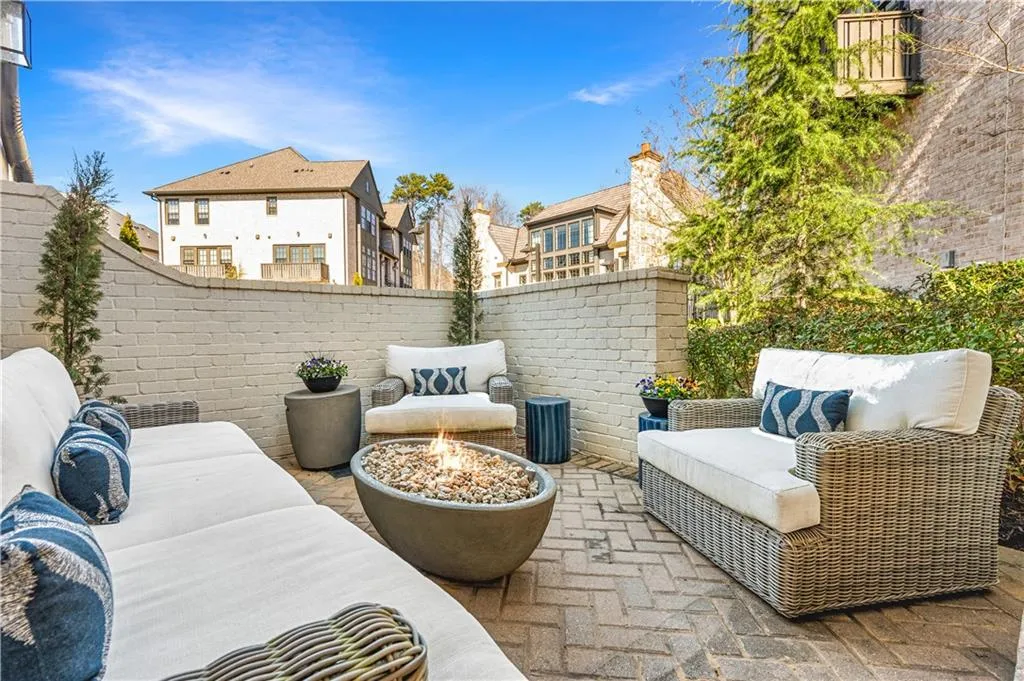 View of patio featuring a fenced backyard, an outdoor living space with a fire pit, and a residential view
