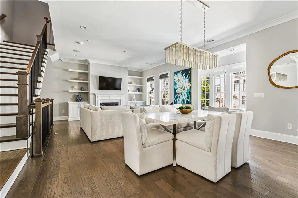 Dining room with baseboards, a fireplace, dark wood finished floors, and crown molding