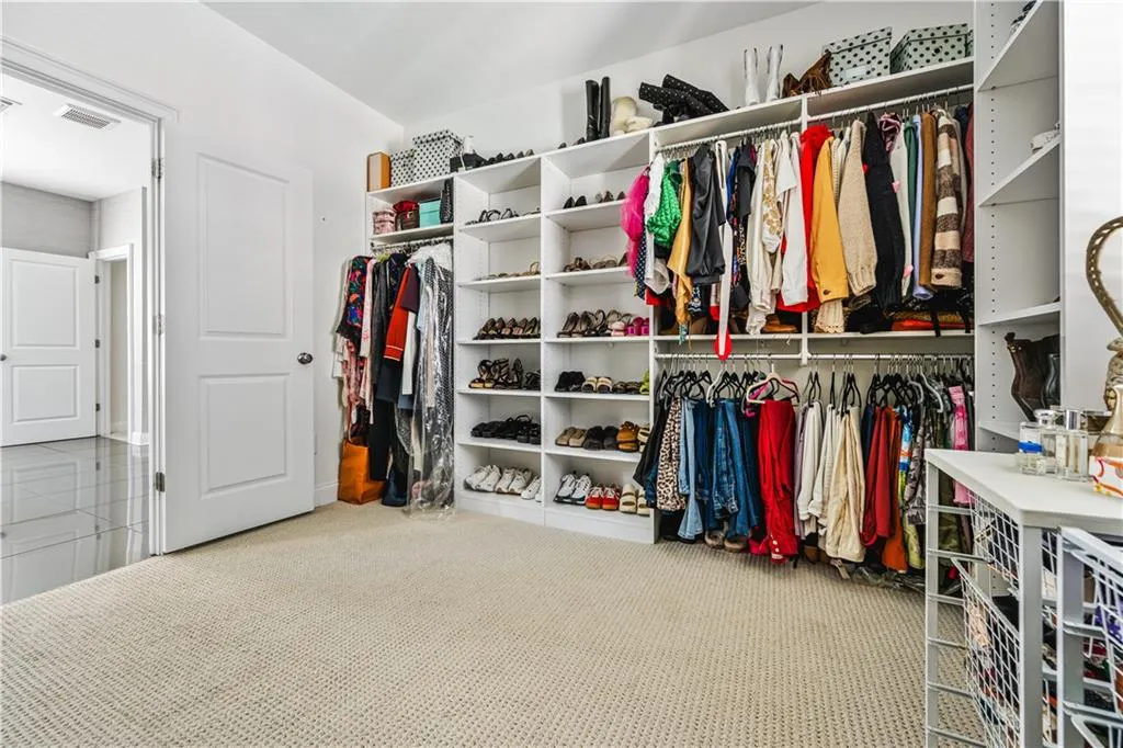 Walk in closet with carpet floors and visible vents