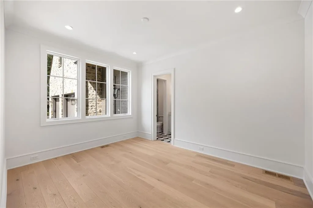 Light wood-finish flooring, recessed lighting, and white walls with crown molding