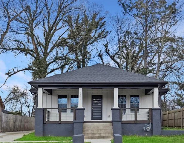 View of front of house featuring a porch, roof with shingles, and board and batten siding