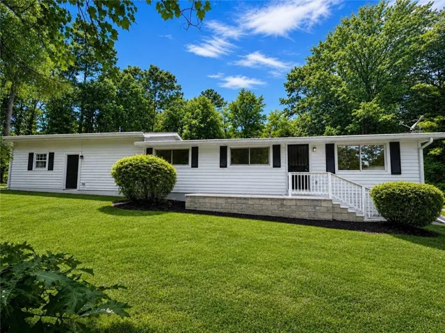 White siding exterior with black shutters and trim