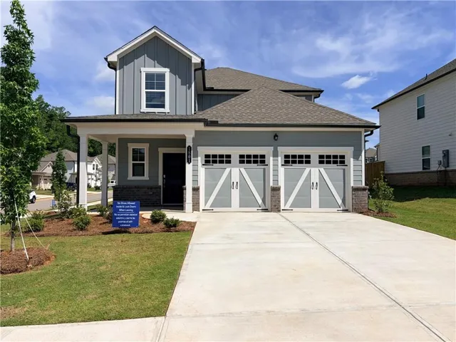 Two-story residence featuring light blue siding with board and batten accents