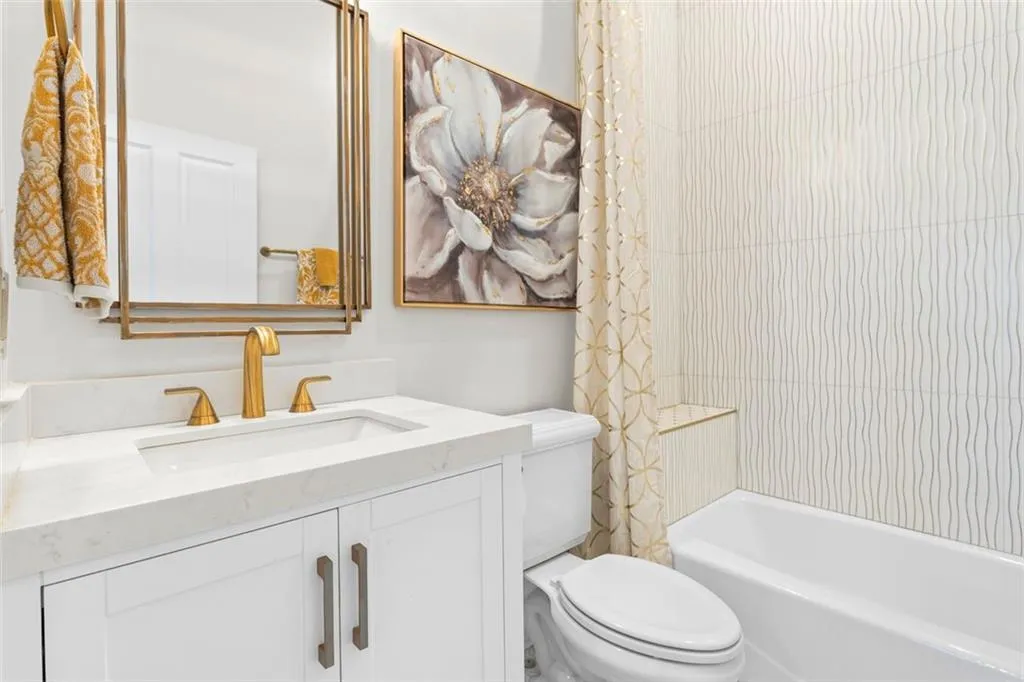 Second bathroom has beautiful tile, mirrors, vanity and faucet