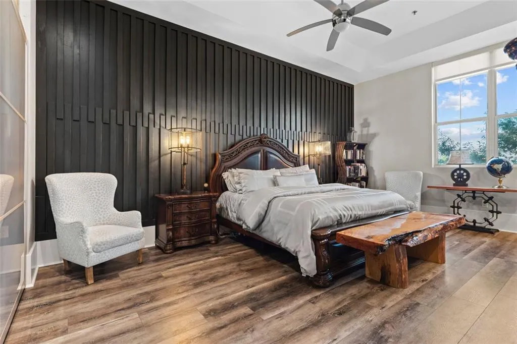 Modern accent wall is stunning in this primary bedroom