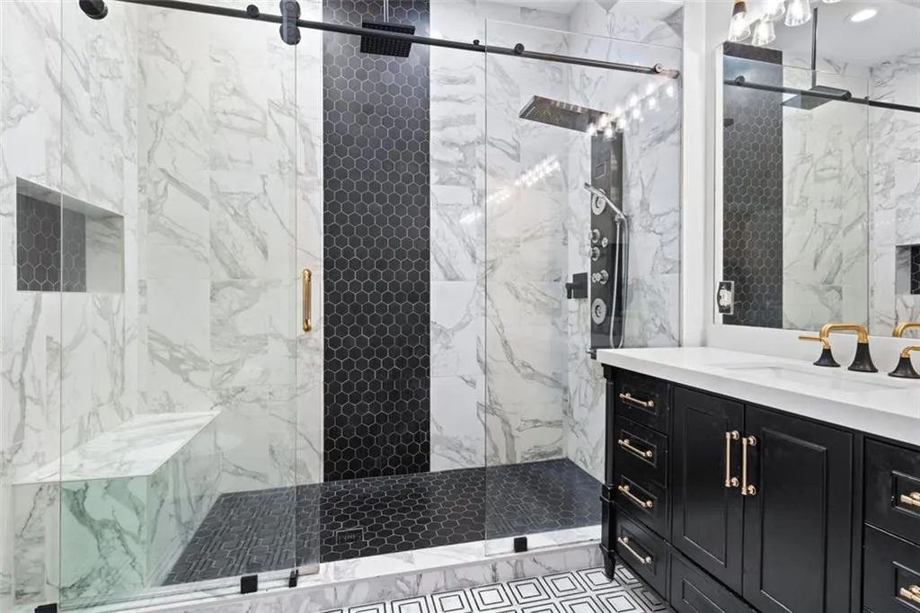 Stunning bath has combination of marble and contemporary tile