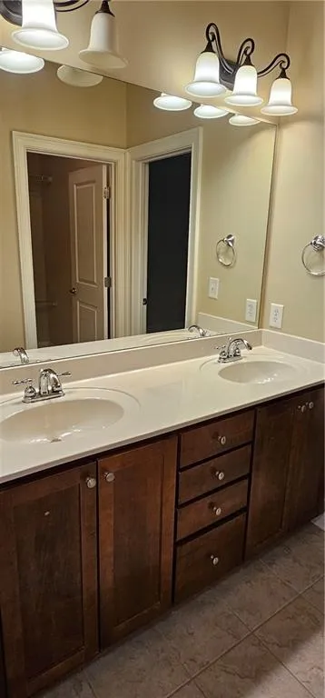 Bathroom with double vanity and tile patterned floors