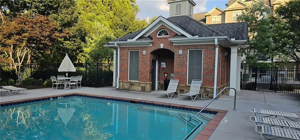 Community pool featuring a patio