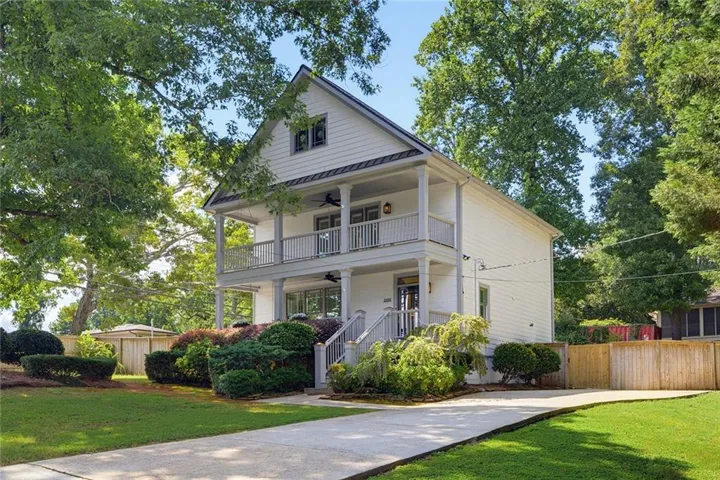 Two-story residence featuring white siding and a gable roof