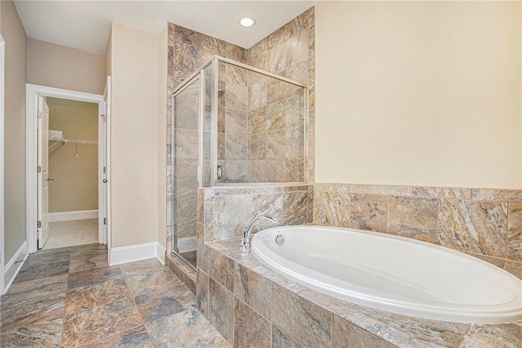 Bathroom featuring separate shower and tub and tile flooring