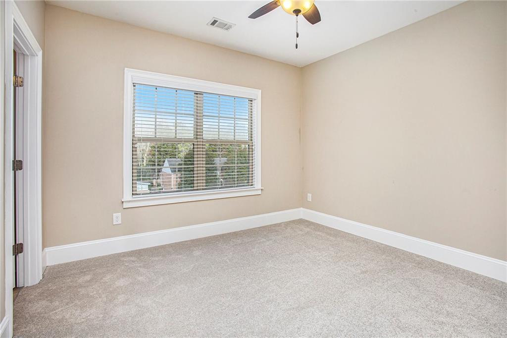 Spare room with light colored carpet and ceiling fan