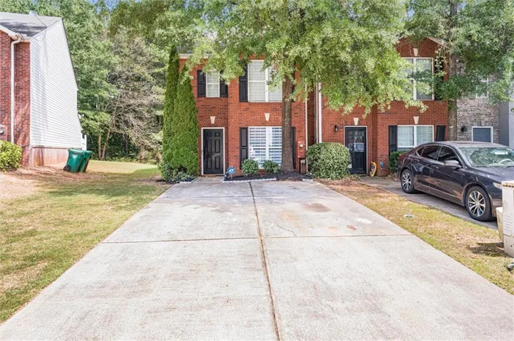 Brick exterior with black shutters and white window trim