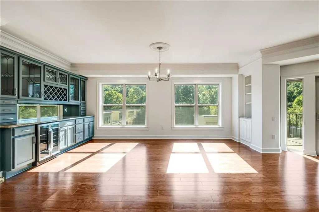 Dining room featuring wine cooler, light hardwood / wood-style floors, and plenty of natural light