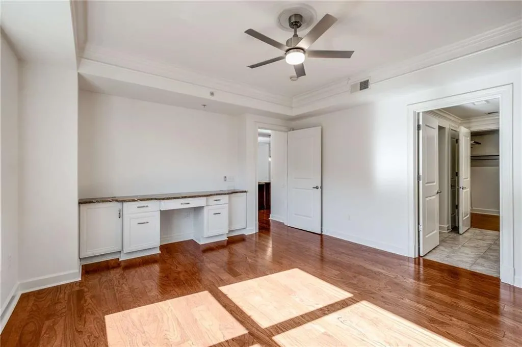 Primary unit has wonderful built in vanity/desk area with granite countertops.  Brand new brushed silver fan with light kit.  This is a very bright, over sized room.