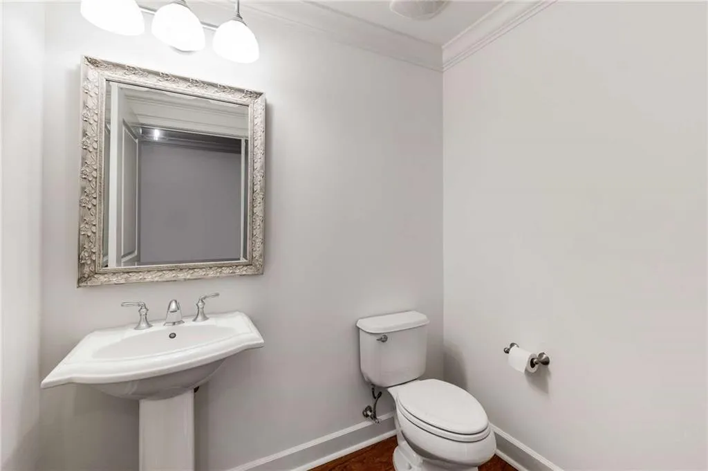 This unit has two full bathrooms and this additional powder room.  Lovely crown molding throughout the entire unit.