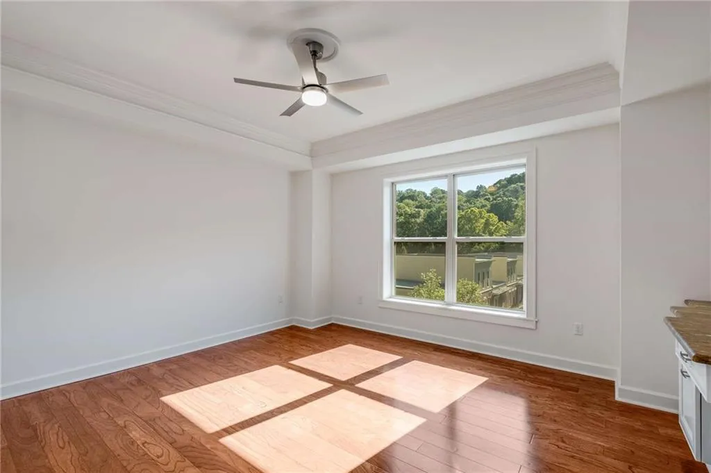 Bedroom featuring ornamental molding, dark hardwood / wood-style flooring, and ceiling fan