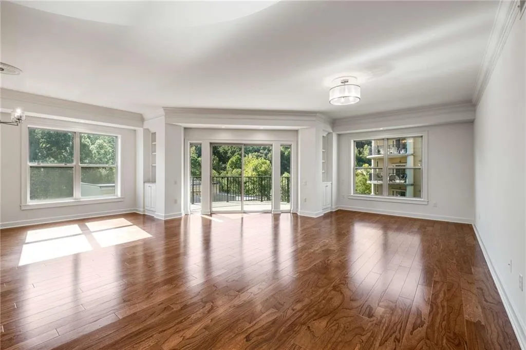 Living room with hardwood / wood-style flooring and ornamental molding