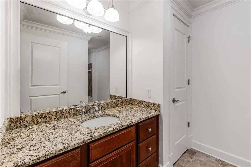 Full secondary bathroom has granite countertop and a full size laundry closet!