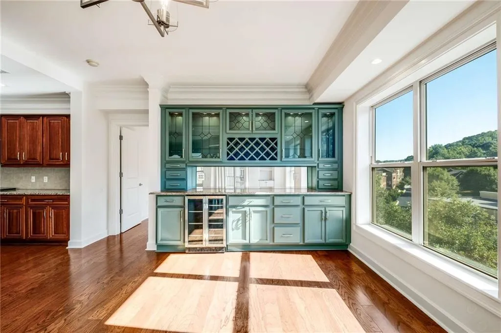 This built in bar/cabinet is perfect for someone who is downsizing from a larger home and has lots of entertaining pieces.  This even includes an extra bar fridge!