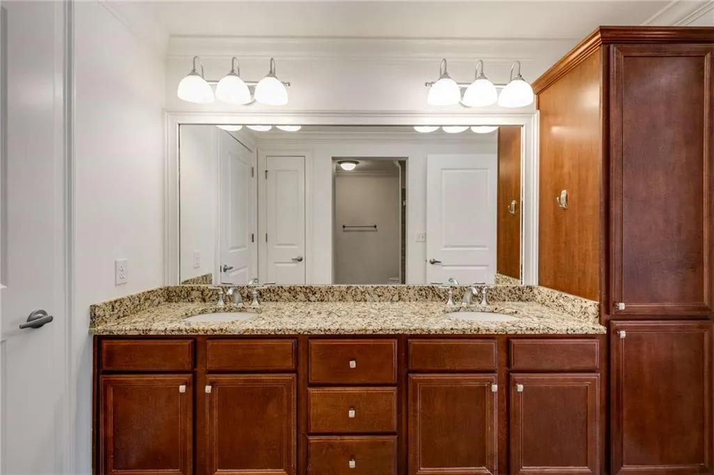 Double vanity with large floor to ceiling storage cabinet.