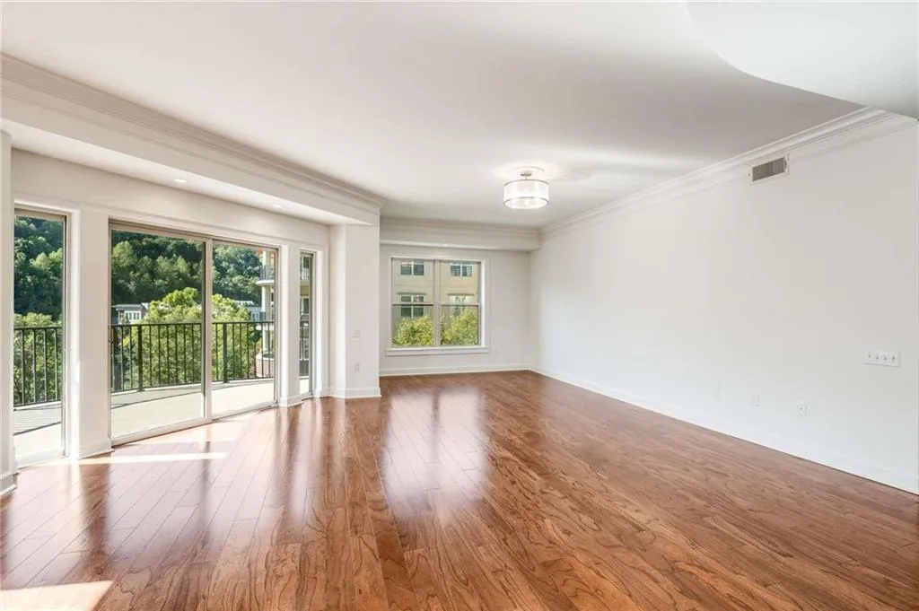 Spare room with crown molding and hardwood / wood-style flooring