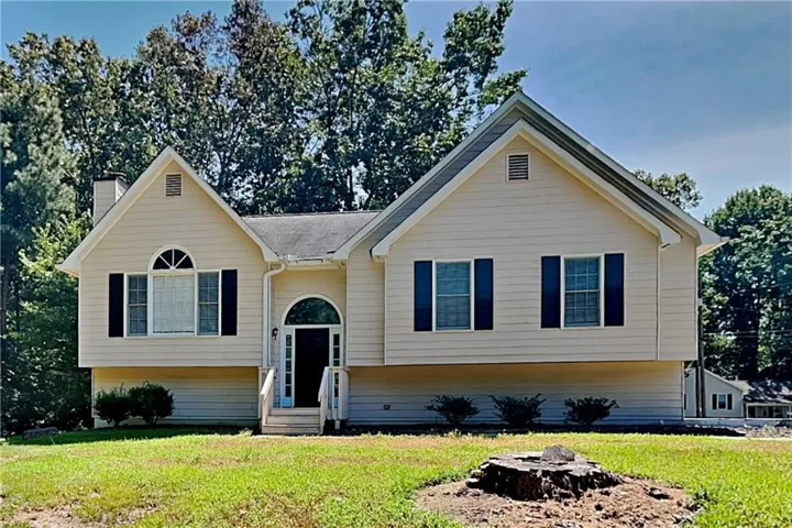 Gable rooflines, arched entry, arched window, exterior shutters, and light-colored siding