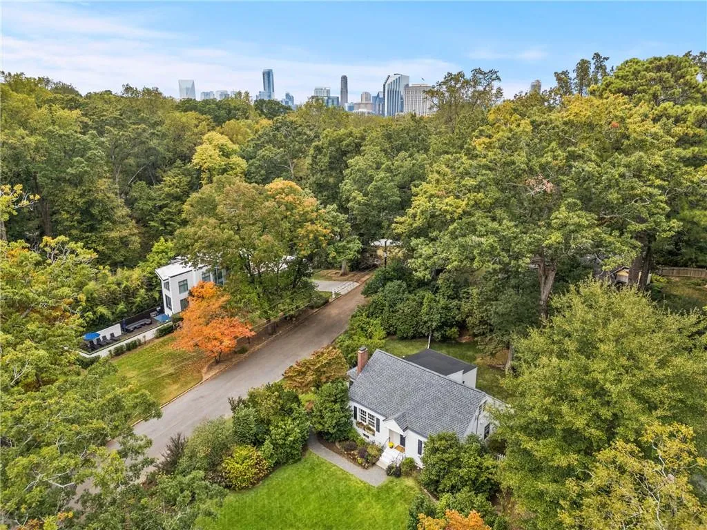 Aerial view highlights the homes tranquil, tree canopied setting in Pine Hills - and oasis of greenery just minutes from the vibrant Buckhead