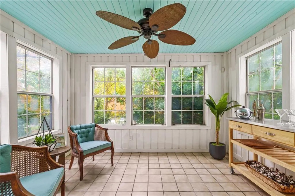An additional sunroom is perfect for a gathering spot to mix drinks and conversation.