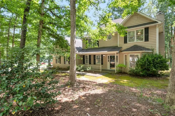 View of front of property with a porch and a chimney