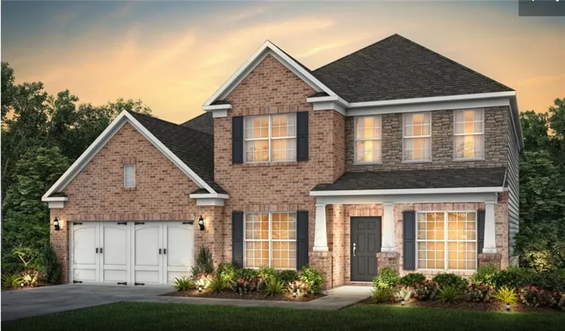 Two-story exterior with a brick and stone facade, covered entry porch with white columns, two-car garage with carriage-style doors, dark shingle roof, and mature landscaping