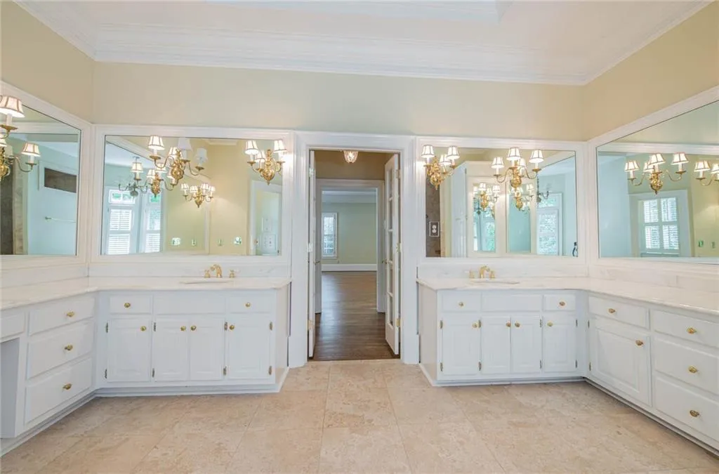 VIEW FROM MASTER BATH INTO MASTER BEDROOM. MASTER BEDROOM FEATURES HIS AND HER CLOSETS